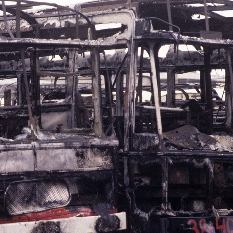 Shells of burnt-out busses after a suicide bombing