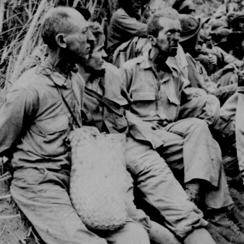 Captured soldiers along the march with their hands tied behind their backs