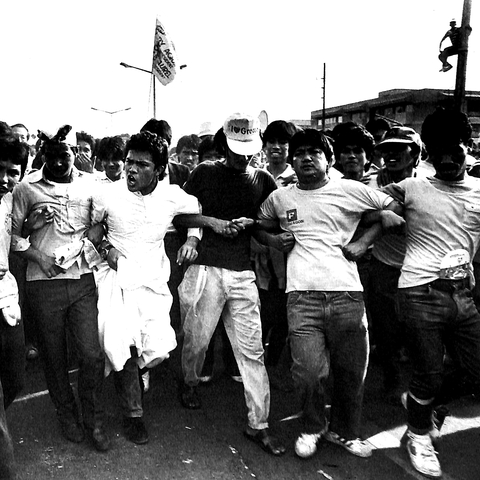 group of protesters with linked arms at Epifanio de los Santos Avenue